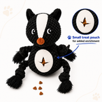 Black and white skunk-shaped dog toy with a small treat pouch on a white background