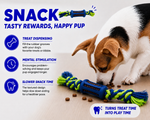 Dog playing with a blue and green chew toy on a light surface.